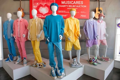 Ensembles worn by K-pop band BTS on their "Dynamite" music video are displayed at the MusiCares Charity Relief auction Press Preview at Julien's Auctions, January 26, 2021, in Beverly Hills, California. The Musicares Charity Relief Auction will be held January 31, 2021. / AFP / VALERIE MACON

