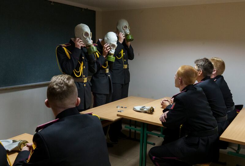 Cadets practise with gas masks in a bomb shelter on the first day of school at a cadet lyceum in Kyiv, Ukraine, in September