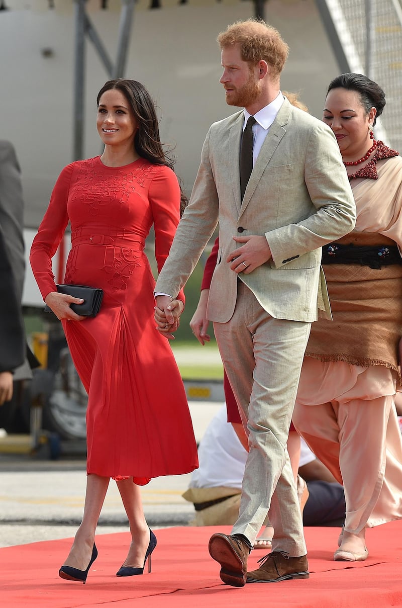 Meghan, Duchess of Sussex, wears Self-Portrait and Manolo Blahnik heels at Fua'amotu airport in Tonga on October 25, 2018.  AFP