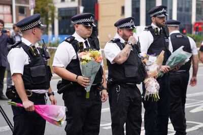 Police officers lay flowers at the scene in Croydon, London, where 15-year-old Elianne Andam was stabbed to death on September 28. PA Wire