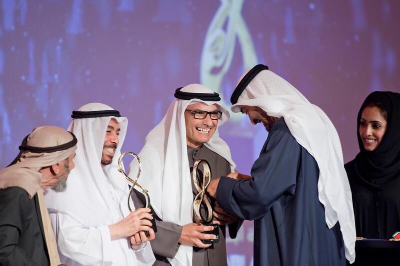 ABU DHABI, UNITED ARAB EMIRATES - January 24, 2012:  (2nd from right) HH General Sheikh Mohamed bin Zayed Al Nahyan Crown Prince of Abu Dhabi Deputy Supreme Commander of the UAE Armed Forces, presents a 2011 Abu Dhabi Award medal to (center) Abdul Raoof Al Mubarak, on behalf of the late, Alsheikh Ahmed Al Mubarak.
( Ryan Carter / Crown Prince Court - Abu Dhabi )