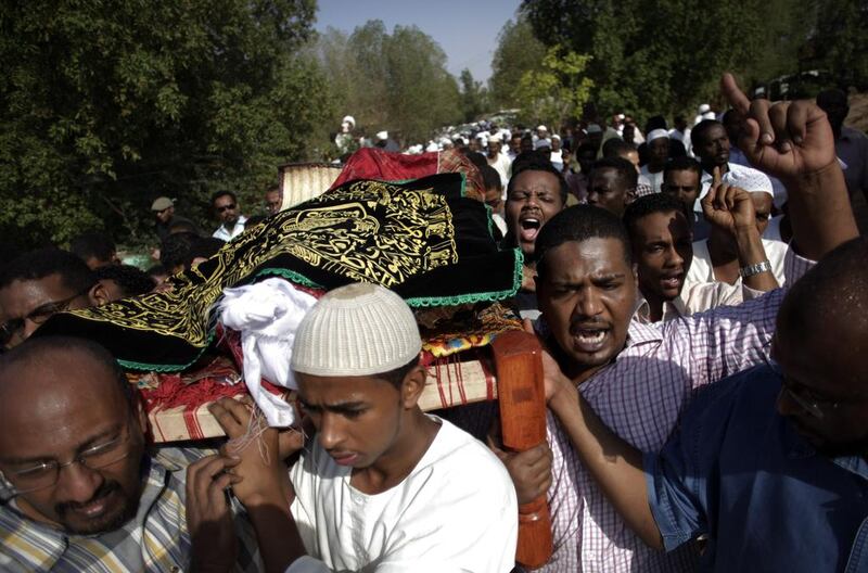 Sudanese men carry the body of Salah Sanhory, 29, who was shot and killed last Friday by security forces, during his funeral at which about 2,000 attended, in Khartoum on the weekend. Khalil Hamra / AP Photo
