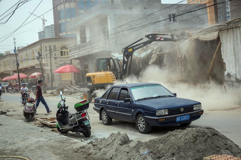 KERIYA, XINJIANG, CHINA - 2017/07/13: A backhoe loader seen destroying traditional homes to build newly houses in the streets of Keriya in the Hotan Prefecture, Xinjiang Uyghur Autonomous Region in China.
Kashgar is located in the north western part of Xinjiang province where nearly 10 million Muslim Uyghurs are living. It is considered as the crossroads linking China to Asia, the Middle East, and Europe, the city has changed under Chinese rule with government development, unofficial Han Chinese settlement to the western province, and restrictions imposed by the Communist Party. The central government of China says it sees Kashgar's development as an improvement to the local economy, but many Uyghurs consider it a threat that is eroding their language, traditions, and cultural identity. The discord has created a separatist movement that has sometimes turned violent, starting a crackdown on what Chinese government see as 'terrorist acts' by religious extremists. Tension has increased with lot more security in the city including restrictions at mosques, after closing and removing most of them in the Xinjiang province, the Chinese authorities have also restricted to the women to wear veils and the young men to grow beards. (Photo by Guillaume Payen/SOPA Images/LightRocket via Getty Images)