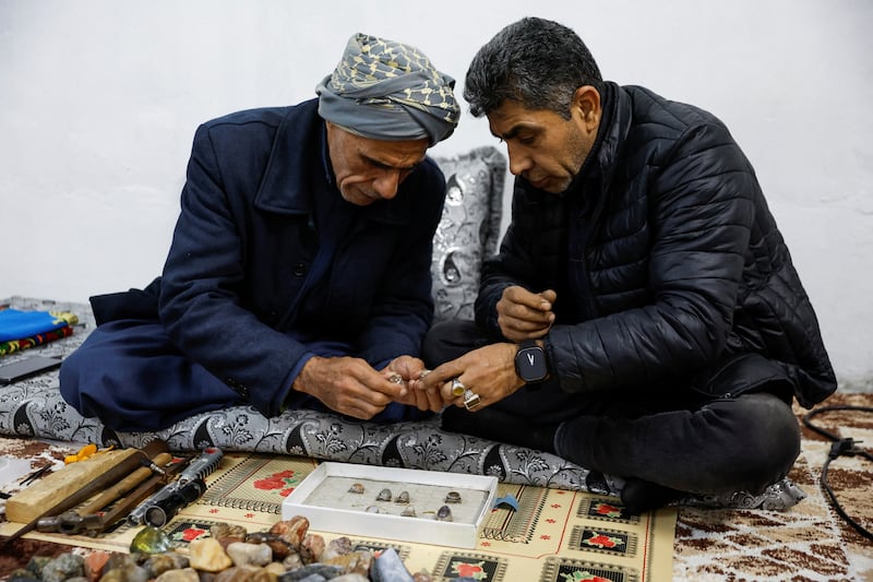 Mr Suaan shows his gemstones to a potential buyer in Mosul