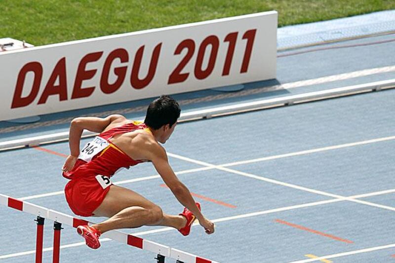 The Chinese 110m hurdler Liu Xiang jumps a hurdle during his heat.

Kevin Frayer / AP Photo