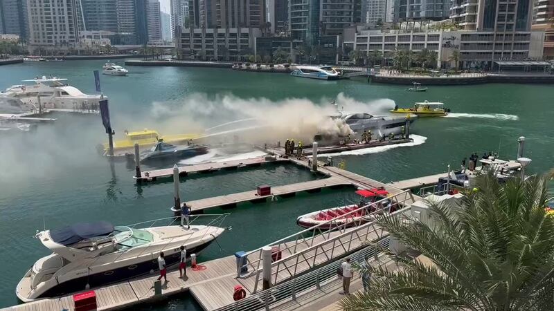 Around noon, crews were spotted extinguishing flames on a vessel docked near the Marina Gate buildings.