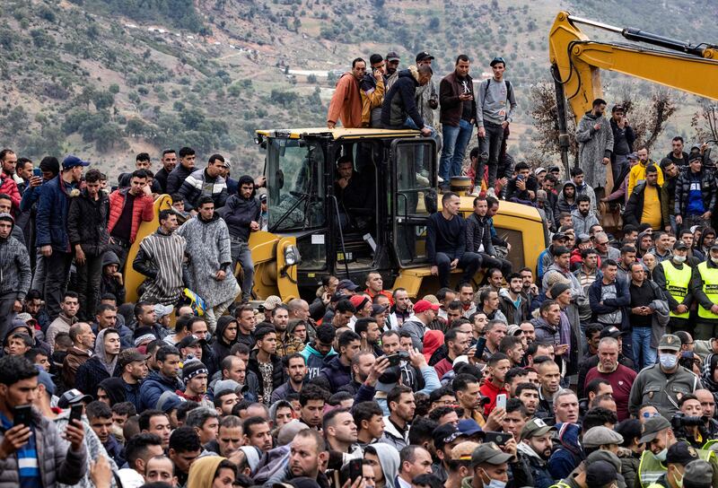 People wait for word on the rescue. AFP