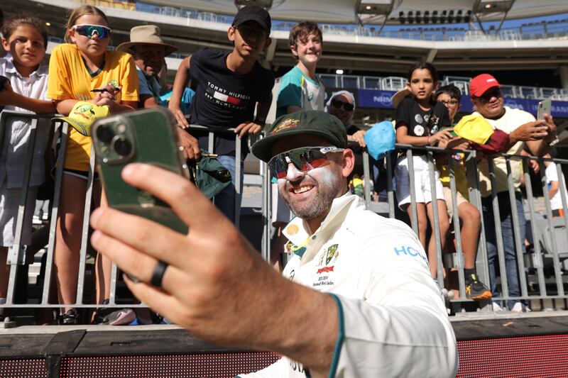 Nathan Lyon of Australia takes a selfie with fans after winning the first Test against Pakistan. EPA 
