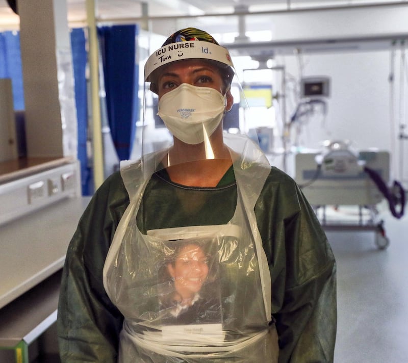 FRIMLEY, ENGLAND - MAY 22: Image released on May 27, Nurse Tina has her name on her visor and a picture of herself on her apron in an Intensive Care ward where she is treating victims of the coronavirus in Frimley Park Hospital in Surrey on May 22, 2020 in Frimley, United Kingdom. The hospital is part of the Frimley Health NHS Foundation Trust which has said that with Covid-19 pressure gradually reducing, they are planning to increase the number of procedures it provides, with more outpatient, diagnostic, endoscopy and surgical services and priority given to the most urgent work, for example, cancer diagnoses and treatments. (Photo by Steve Parsons - Pool/Getty Images)