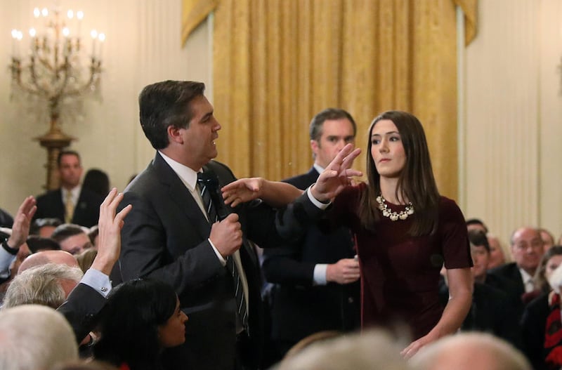 FILE PHOTO: A White House intern reaches for and tries to take away the microphone held by CNN correspondent Jim Acosta as he questions U.S. President Donald Trump during a news conference at the White House in Washington, U.S., November 7, 2018. Picture taken November 7, 2018. REUTERS/Jonathan Ernst/File Photo