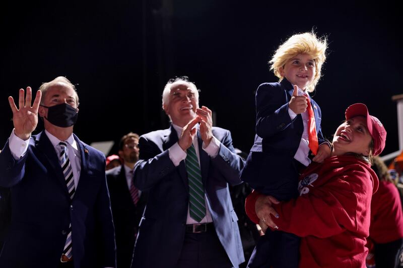 Supporters, including a child dressed as Trump and U.S. Representative Mike Kelly (R-PA), react as U.S. President Donald Trump holds a campaign rally at John Murtha Johnstown-Cambria County Airport in Johnstown, Pennsylvania, U.S. REUTERS