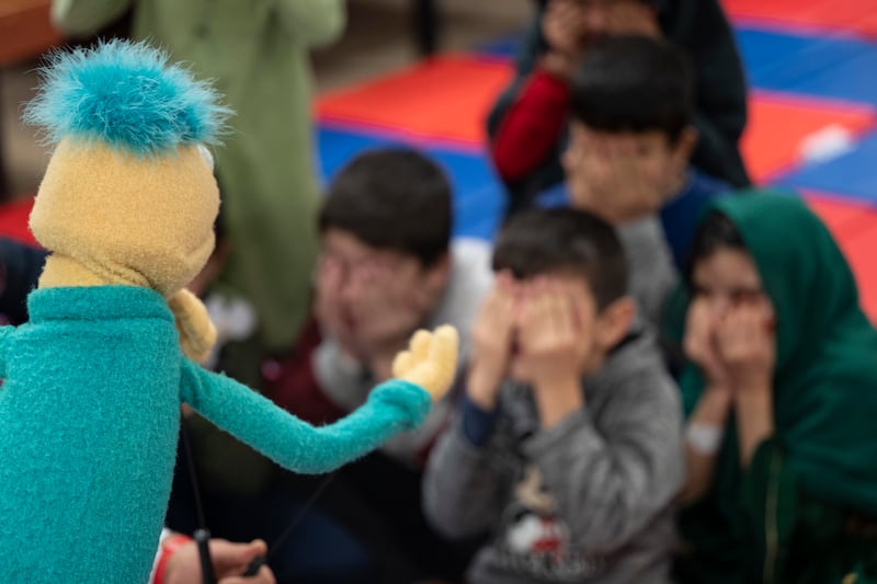 Afghan children interact with a Muppet during a 'Sesame Street' event in Liberty Village, Joint Base McGuire-Dix-Lakehurst, New Jersey. Photo: Tech Sgt Matthew B Fredericks / US Air Force