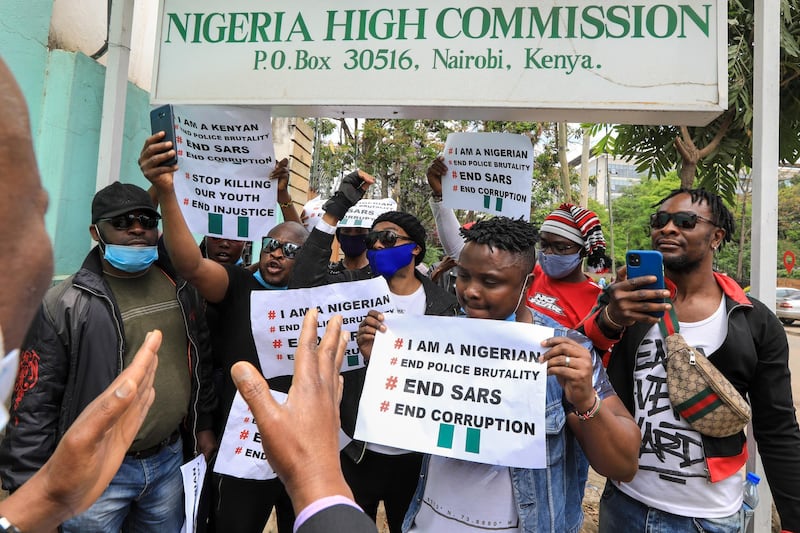 Nigerians living in Kenya hold placards and shout slogans during a protest against the Nigerian Special Anti-Robbery Squad (SARS), outside the Nigeria High Commission offices in Nairobi, Kenya.  EPA