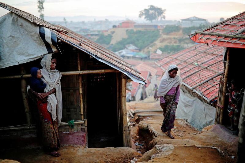 Rohingya refugee women go about their day at the Balukhali camp in Cox's Bazar, Bangladesh. Reuters