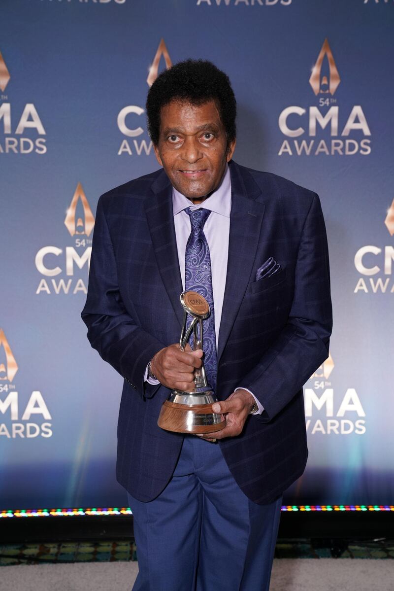Charley Pride holds his Willie Nelson Lifetime Achievement Award backstage at the 54th annual Country Music Association Awards in Nashville, Tennessee. Reuters