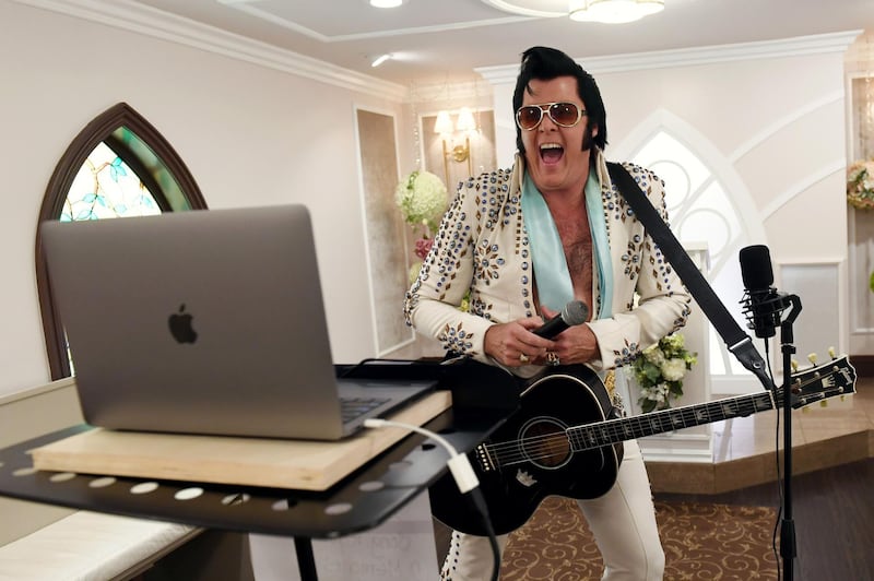 Elvis Presley impersonator and chapel co-owner Brendan Paul performs a live wedding vow renewal ceremony using the Zoom videoconferencing software for a couple from Texas celebrating their 50th anniversary amid the spread of the coronavirus at Graceland Wedding Chapel in Las Vegas, Nevada.  Getty Images