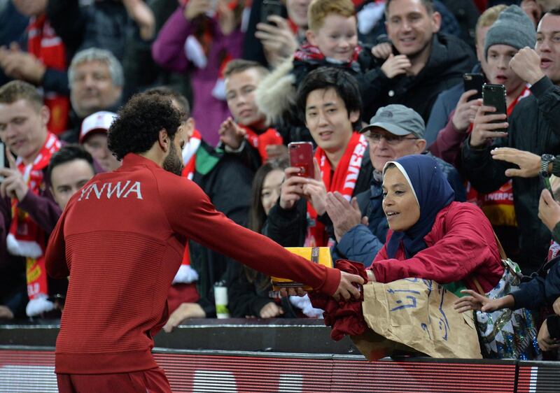 Mohamed Salah receives a gift from a fan after the recent Champions League match against Red Star at Anfield. Reuters