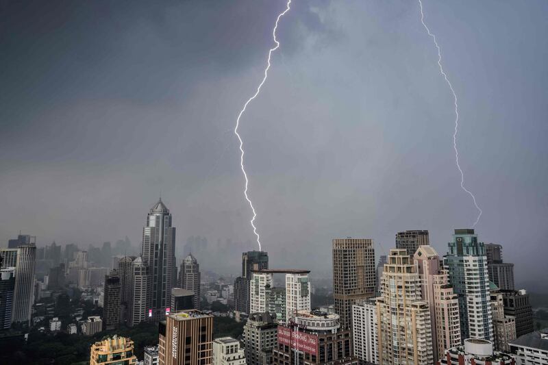Lightning bolts strike buildings during a thunderstorm over Thailand's capital Bangkok. AFP
