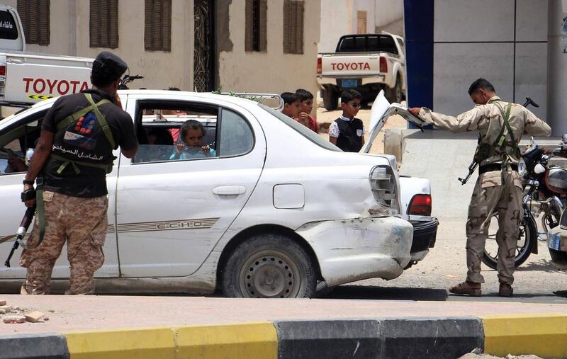 Yemeni security forces inspect vehicles at a checkpoint in Mukalla on July 19, 2016, a day after 11 people were killed in twin bombings claimed by Al Qaeda. With the extremists driven out of the city in south-western Yemen, Omani authorities are concerned that they might try to cross the border. Abduljabbar Bajubair / AFP