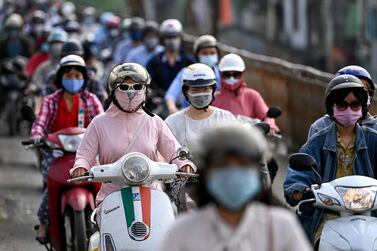 Morning commuters wear face masks in Hanoi. AFP