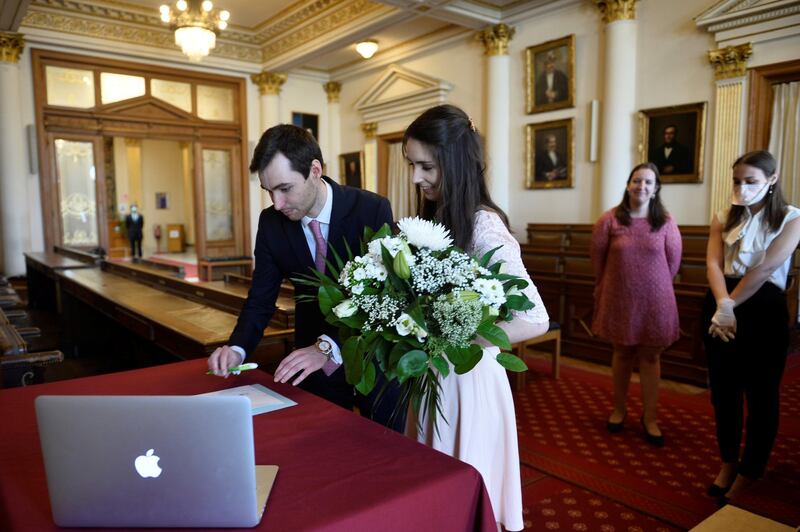 Roxanne, 25, a French lawyer working in Belgium, and Nicolas, 28, a real estate agent, attend their wedding ceremony despite the coronavirus disease (COVID-19) outbreak, in Brussels, Belgium April 11, 2020. Only the witnesses were allowed to the ceremony. REUTERS/Johanna Geron