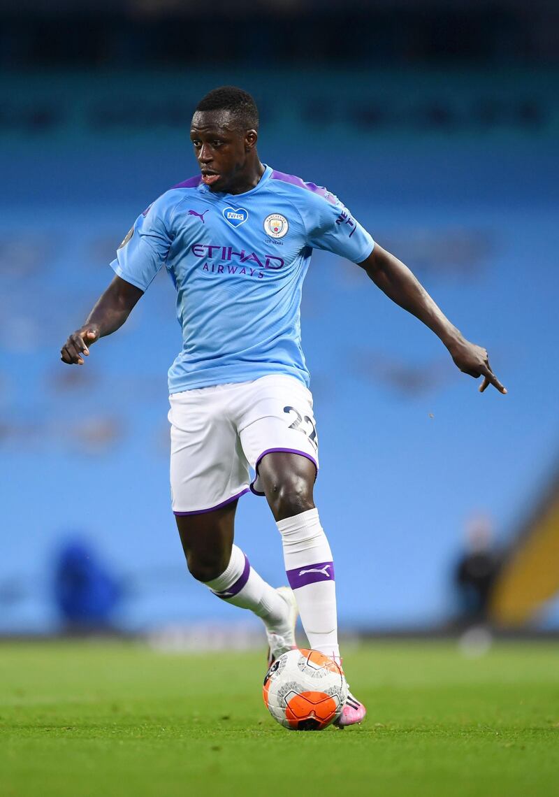 MANCHESTER, ENGLAND - JULY 02: Benjamin Mendy of Manchester City runs with the ball during the Premier League match between Manchester City and Liverpool FC at Etihad Stadium on July 02, 2020 in Manchester, England. Football Stadiums around Europe remain empty due to the Coronavirus Pandemic as Government social distancing laws prohibit fans inside venues resulting in games being played behind closed doors. (Photo by Laurence Griffiths/Getty Images)