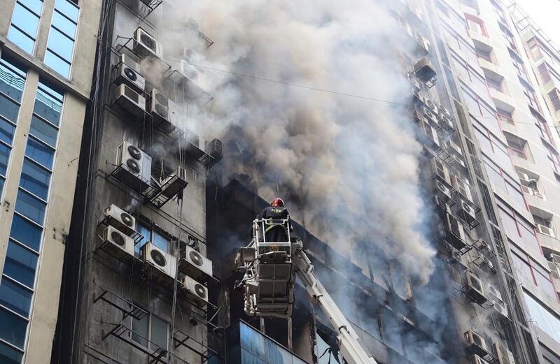 A firefighter works to douse the fire. AP Photo