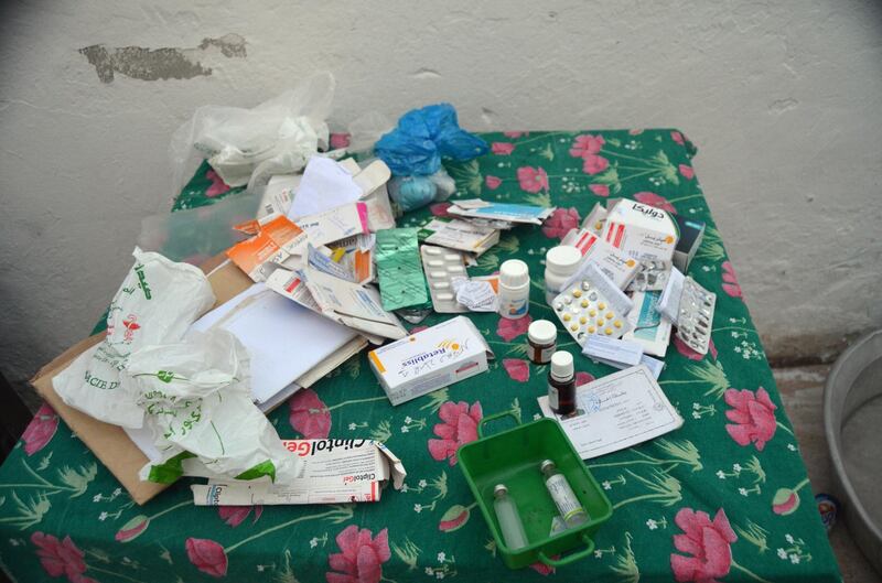 A tables bearing medicines for Ridha's diabetic mothet and her medical bills. Simon Speakman Cordall for The National