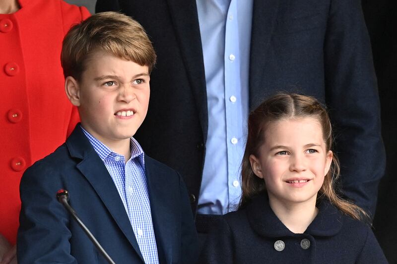 George and Charlotte check a music setup backstage before a concert at Cardiff Castle in Wales, on June 4, 2022. Reuters