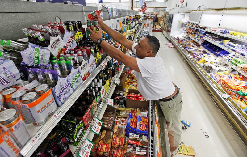 Store owner B. J. Singh, replaces bottles on shelves Miller's Mart food store in Mineral, Va., a small town northwest of Richmond near the epicenter of an earthquake that struck Tuesday, Aug. 23, 2011. The most powerful earthquake to strike the East Coast in 67 years shook buildings and rattled nerves from South Carolina to Maine. (AP Photo/Steve Helber) *** Local Caption ***  East Coast Quake.JPEG-0a680.jpg