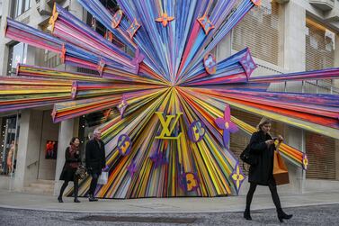 Shoppers pass colorful store-front design on the front of a Louis Vuitton store. A 2018 survey found that 53% of millennials expect to become millionaires at some stage in their lives. Bloomberg
