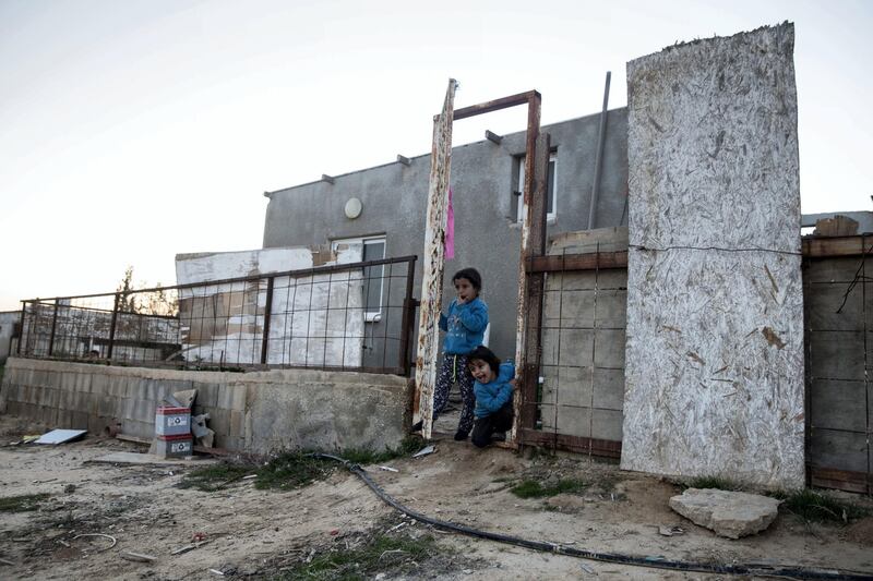 A  family at their home in the unrecognized Bedouin village of al-Porat in the Negev Desert near the city of Arad on February 2,2018. There is a plan to build to build a giant phosphate mine thats estimated to hold 65 million tons of phosphate  unrecognized village of al-Poraa near the city of Arad in the Negev Desert on February 4,2018. 
Israel's Knesset is scheduled to discuss the plan by Israel Chemicals subsidiary Rotem Amfert to build a mine in the area which a committee of ministers have already approved, despite the area is populated. The Beduins living in the area and also residents of Arad fear the complications of the toxic fumes on their health.many of the Bedouins have lived in the area for generations and are afraid the mine could cause the government to evict them from their homes . (Photo by Heidi Levine for The National).
