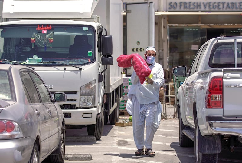 Abu Dhabi, United Arab Emirates, May 7, 2020.  A man carries a sack of onions at the open section of the Al Mina Vegetables and Fruits Market during the time of Ramadan and the Coronavirus pandemic.
Victor Besa/The National
Section:  NA
Reporter: