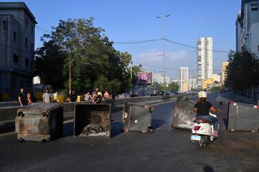 Anti-government protesters block the main road by garbage bins during a protest over deteriorating living conditions in downtown Beirut, Lebanon. EPA