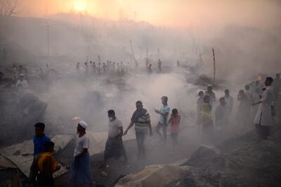 Rohingya refugees try to salvage their belongings after a major fire in Cox's Bazar, Bangladesh, on March 5. AP