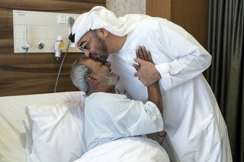 ABU DHABI, UNITED ARAB EMIRATES -  March 11, 2018: HH Sheikh Mohamed bin Zayed Al Nahyan, Crown Prince of Abu Dhabi and Deputy Supreme Commander of the UAE Armed Forces (2nd L), bids farewell to Fadel Mahmoud Saleh (L), who is in Abu Dhabi receiving medical assistance at Burjeel Hospital. 
( Ryan Carter for the Crown Prince Court - Abu Dhabi )
---