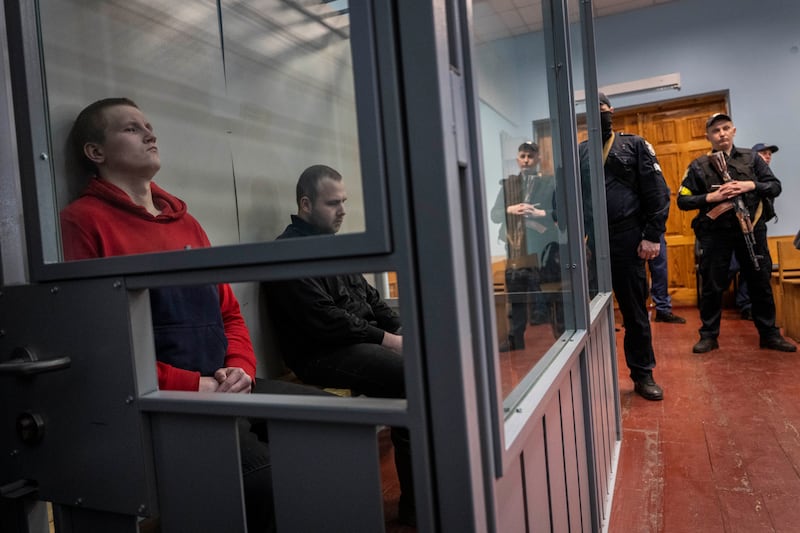 Russian soldiers Alexander Alexeevich Ivanov and Alexander Vladimirovich Bobykin, left, attend their trial hearing in Kotelva, northeastern Ukraine. AP Photo