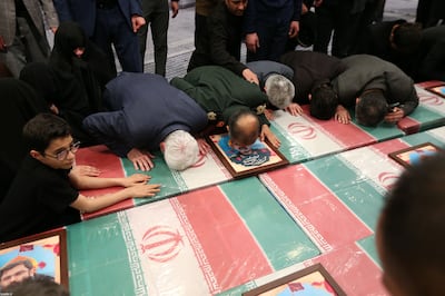 Family and relatives of members of Iranian revolutionary guards corps, who were killed in Syria, mourning over their coffins before their funeral in Tehran, Iran, on April 4. EPA