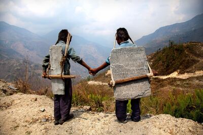 Two young brothers carry heavy stones in the Himalayas. Photo by Lisa Kritsine