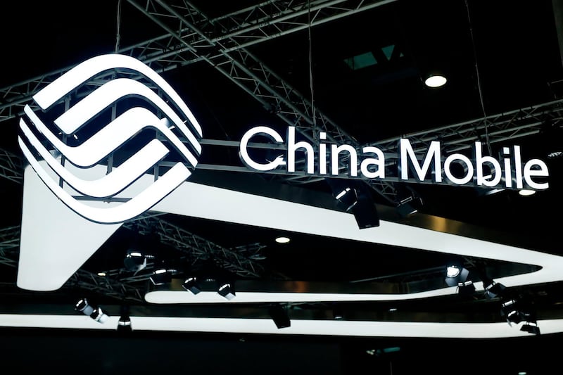 (FILES) In this file photo taken on February 26, 2019, the China Mobile logo is displayed at the Mobile World Congress (MWC) in Barcelona. US regulators on May 9, 2019, denied a request by China Mobile to operate in the US market and provide international telecommunications services, saying links to the Chinese government pose a national security risk. The Federal Communications Commission said that because of China Mobile USA's ownership and control by the Chinese government, allowing it into the US market "would raise substantial and serious national security and law enforcement risks."  / AFP / Pau Barrena
