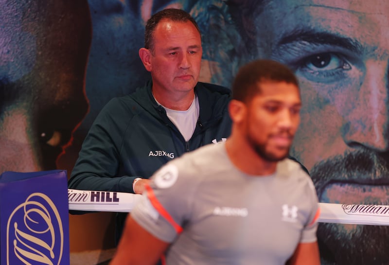 Trainer Robert McCracken looks with Anthony Joshua in the ring. Getty