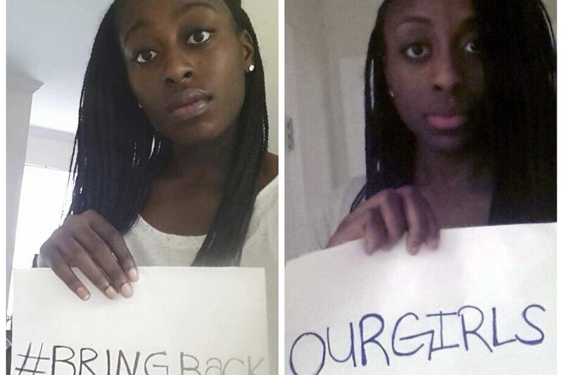 Nneka, left, and Chiney, right, Ogwumike hold a picture with the message 'Bring Back Our Girls'. The sisters, professional basketball players in the WNBA, have joined the scores around the globe calling for the return of Nigerian school girls who were kidnapped by the Boko Haram terrorist group. AP Photo 