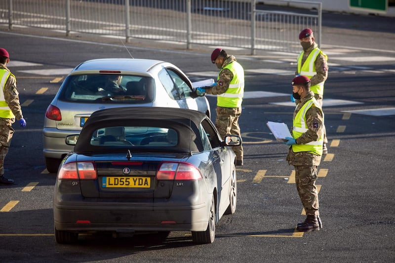 Members of the military check the paperwork of drivers. Bloomberg