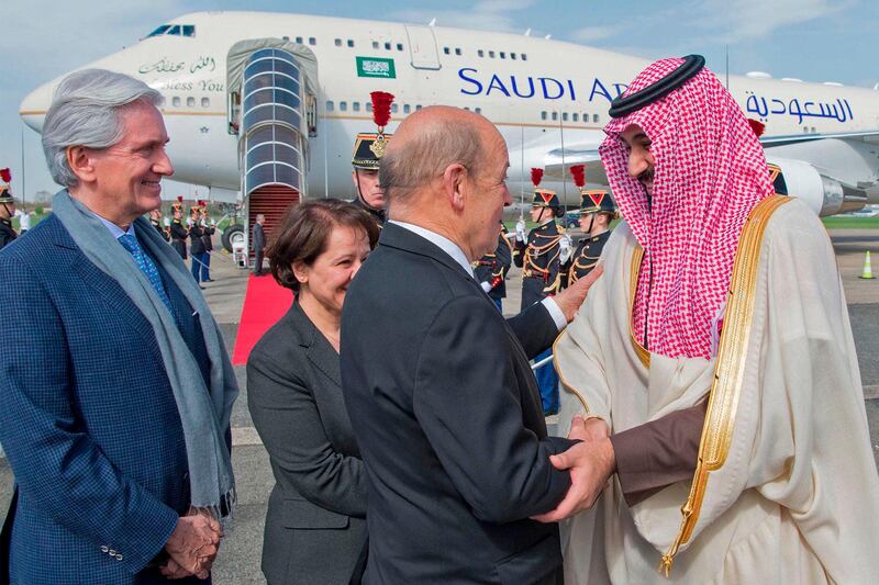 French Foreign Affairs Minister Jean-Yves Le Drian (2nd-R) welcomes Saudi Arabia's crown prince Prince Mohammed bin Salman (1st-R) next to  French Ambassador to Saudi Arabia Francois Gouyette (1st-L) at Le Bourget airport, north of Paris, on April 8, 2018.
Saudi Arabia's crown prince Prince Mohammed bin Salman arrived in France on April 8, for the next leg of a global tour aimed at reshaping his kingdom's austere image as he pursues his drive to reform the conservative petrostate. / AFP PHOTO / Ahmed NURELDINE