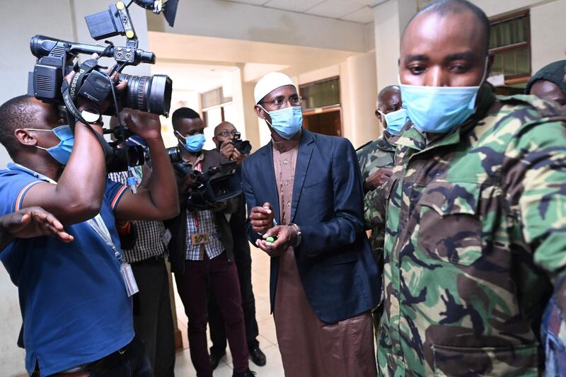 Mohamed Ahmed Abdi is escorted back to custody after being found guilty of aiding the gunmen involved in the Westgate Mall attack of September 2013.  AFP