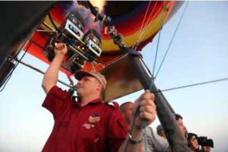 October 2, 2009 / Abu Dhabi / Piotr Gorny (cq) a hot air balloon pilot from Balloon Adventures, gets ready for take off by heating the air inside the balloon in the Emirate of Abu Dhabi October 2, 2009.  (Sammy Dallal / The National)



 *** Local Caption ***  sd-100309-balloon-10.jpg
