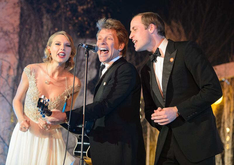 Prince William, right, sings with US singers Jon Bon Jovi, centre, and Taylor Swift during the Centrepoint gala dinner at Kensington Palace in London, on November 26, 2013. AFP