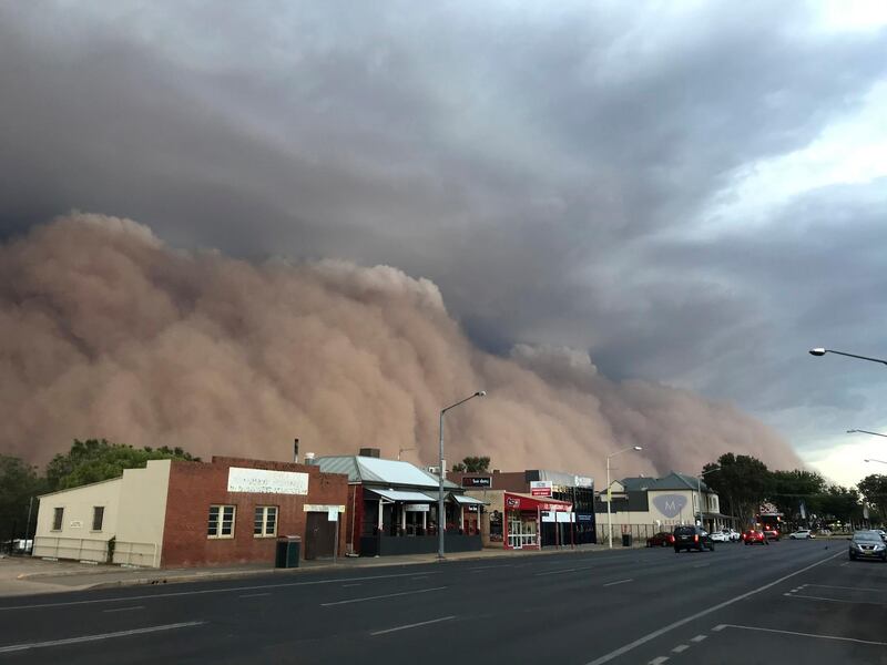 A dust cloud billows over a street in Dubbo, Australia, 400 kms west of Sydney.  AP