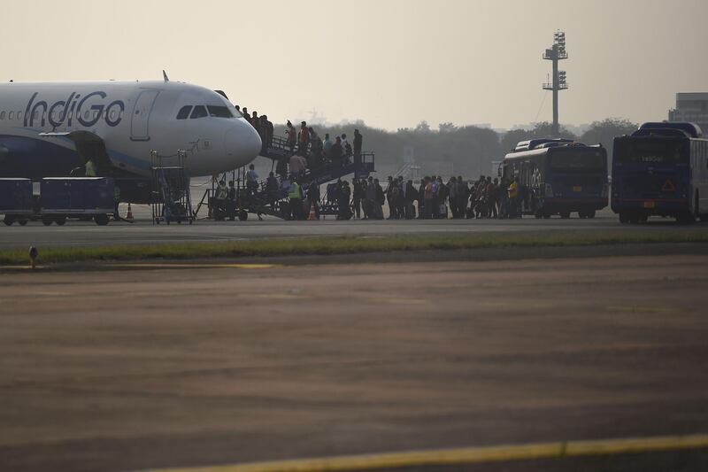 In this photograph taken on March 2, 2020, passengers queue to board on an IndiGo aircraft at Indira Gandhi International airport in New Delhi. / AFP / Money SHARMA
