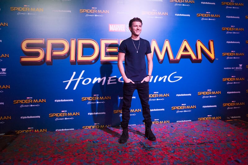 Tom Holland, in black jeans and a blue shirt, poses during a 'Spider-Man: Homecoming' event in Singapore on June 6, 2017. Getty Images